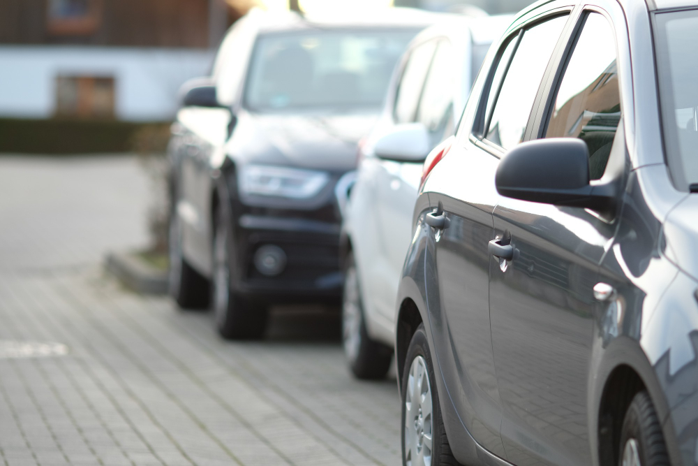 closeup-shot-black-car-parking-lot-with-blurred-background